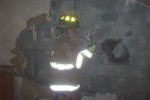 Firefighter breaking down wall with sledgehammer Thumbnail