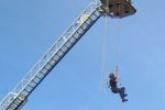 Firefighter going down the crane using rope Thumbnail