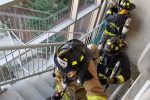 Firefighters inspecting a building Thumbnail
