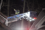 Firefighter on fire crane at night Thumbnail